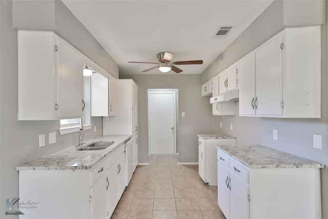 kitchen featuring light tile patterned flooring, white cabinetry, ceiling fan, and sink