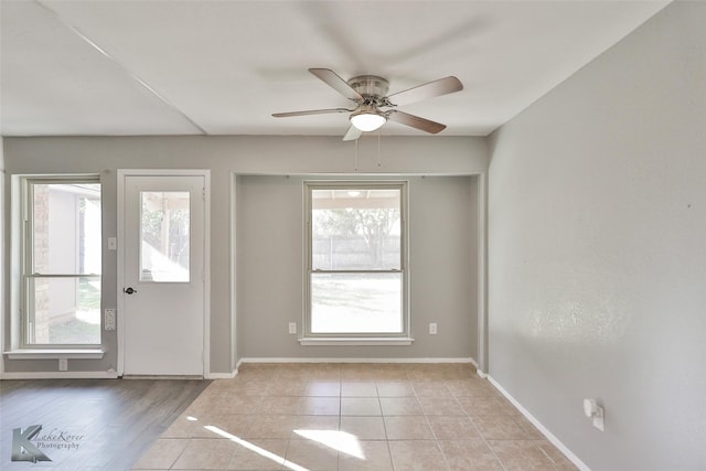 doorway with ceiling fan, plenty of natural light, and light wood-type flooring