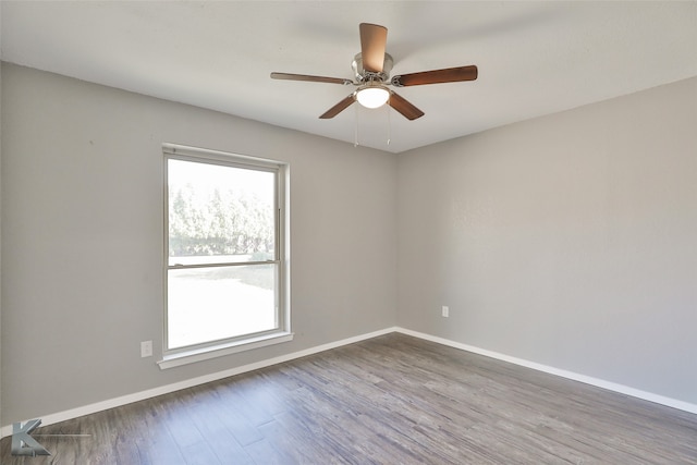 unfurnished room featuring ceiling fan and dark hardwood / wood-style flooring