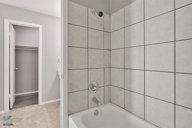 bathroom with tile patterned flooring and tiled shower / bath