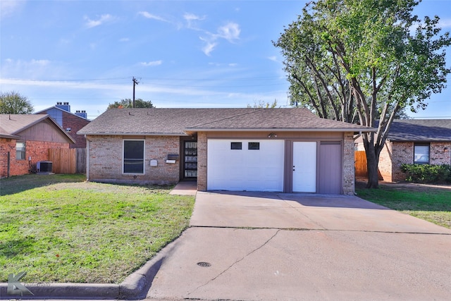 ranch-style home featuring central air condition unit, a front lawn, and a garage