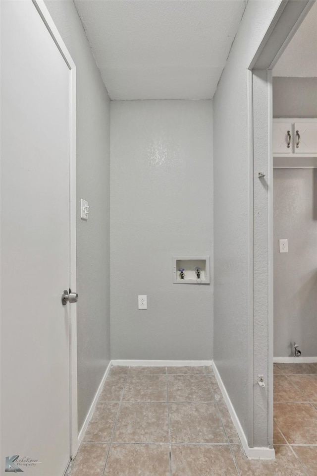 laundry room featuring light tile patterned floors and hookup for a washing machine