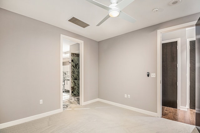 carpeted spare room featuring ceiling fan