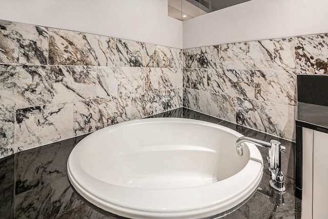 bathroom with tile walls and tiled tub