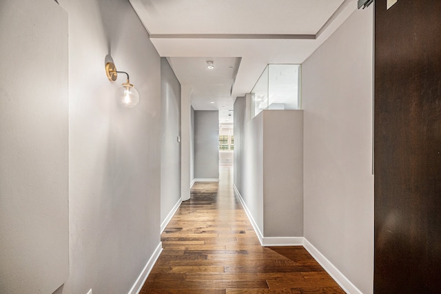 hallway featuring a barn door and wood-type flooring