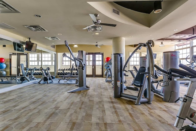 workout area with light carpet, ceiling fan, and a healthy amount of sunlight