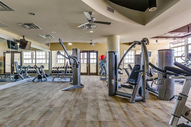 exercise room with ceiling fan and light colored carpet