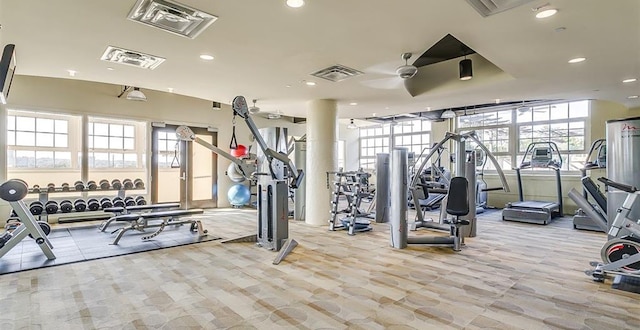 exercise room with ceiling fan and carpet floors