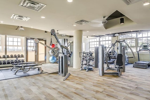 exercise room featuring light carpet