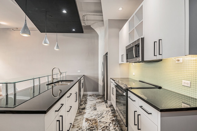 kitchen with decorative light fixtures, sink, white cabinetry, and stainless steel appliances