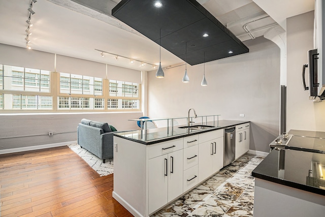 kitchen featuring a wealth of natural light, white cabinetry, sink, stainless steel appliances, and light wood-type flooring