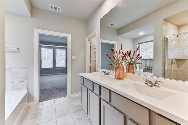 bathroom featuring independent shower and bath, vanity, tile patterned floors, and a healthy amount of sunlight