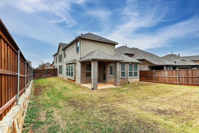 back of property featuring a patio and a lawn