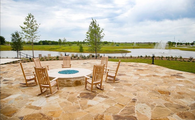 view of patio / terrace with a water view and a fire pit