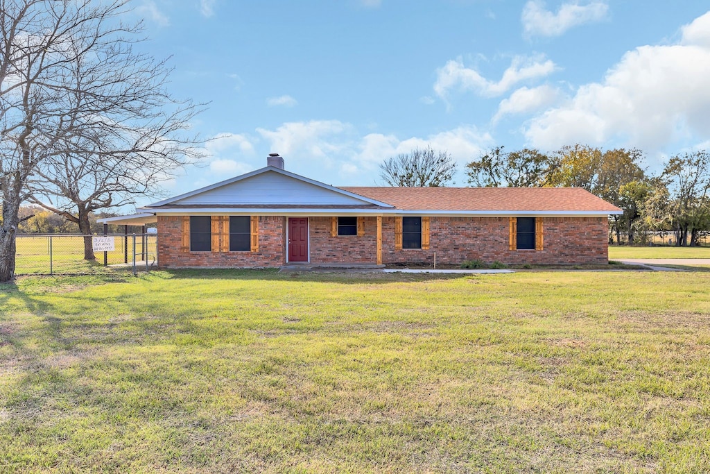 back of house featuring a lawn