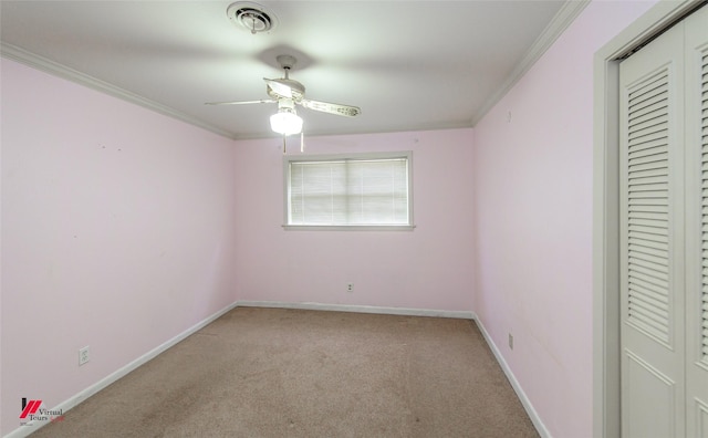 unfurnished bedroom with ceiling fan, ornamental molding, light carpet, and a closet