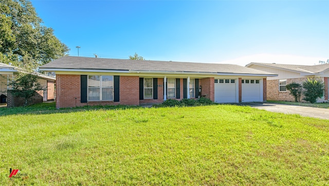 ranch-style house featuring a garage and a front lawn