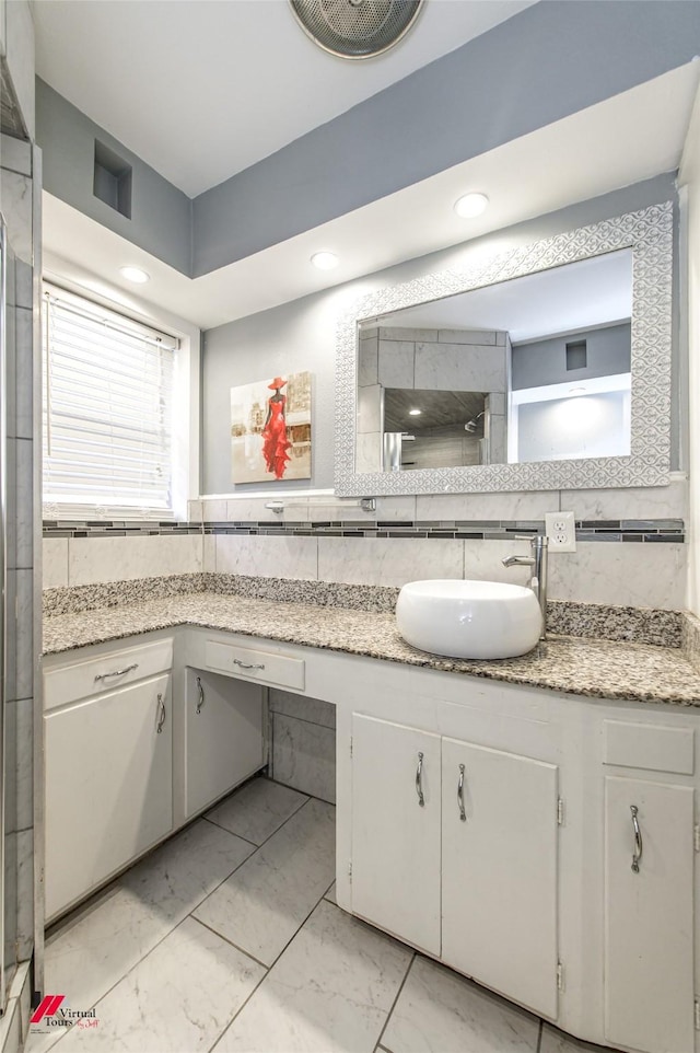 bathroom featuring decorative backsplash and vanity