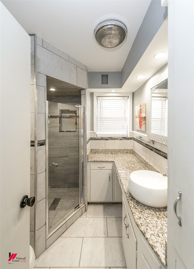 bathroom with tile patterned flooring, vanity, and an enclosed shower