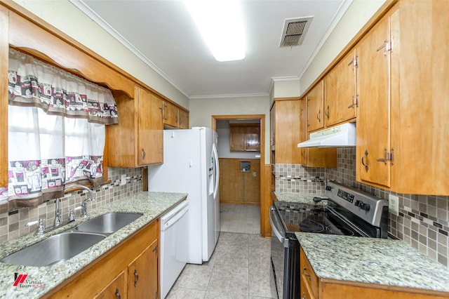 kitchen featuring decorative backsplash, sink, light stone counters, and white appliances