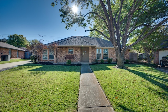 view of front of house featuring a front yard and central air condition unit