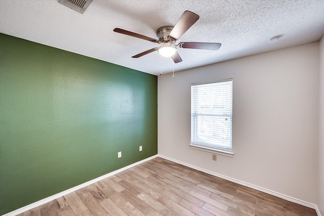 unfurnished room with ceiling fan, a textured ceiling, and light hardwood / wood-style flooring