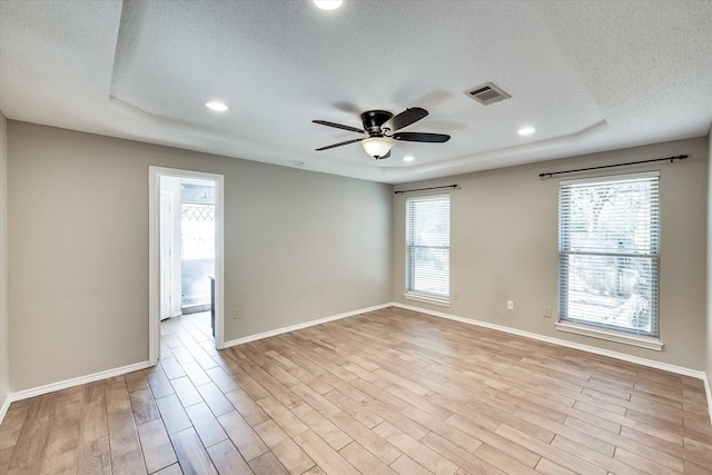 empty room featuring light hardwood / wood-style floors, plenty of natural light, and ceiling fan