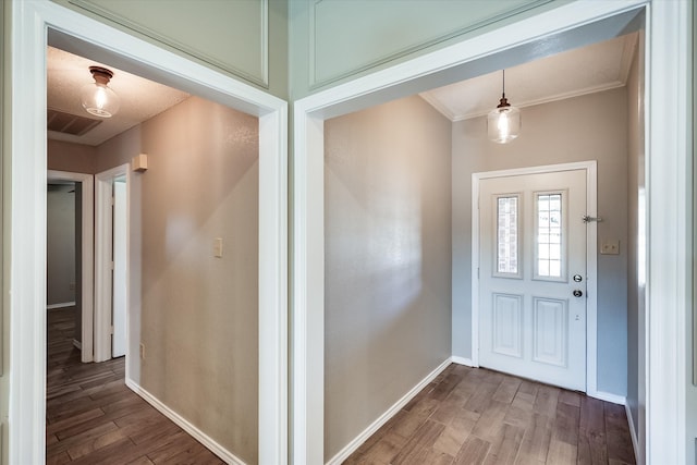 entrance foyer featuring wood-type flooring and ornamental molding