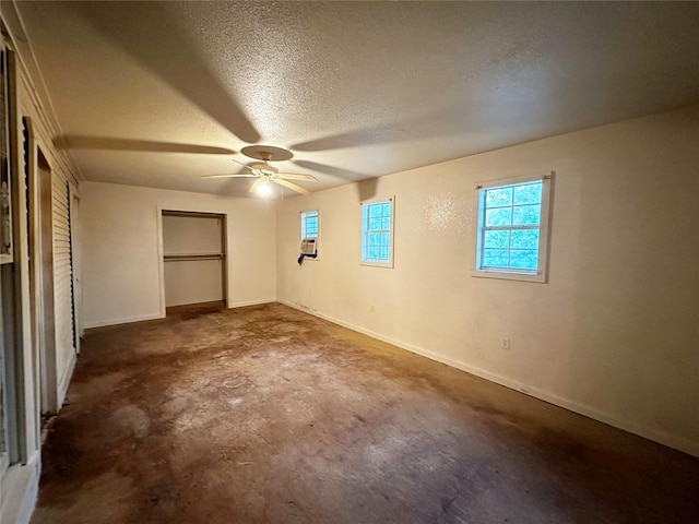 unfurnished bedroom with a textured ceiling and ceiling fan