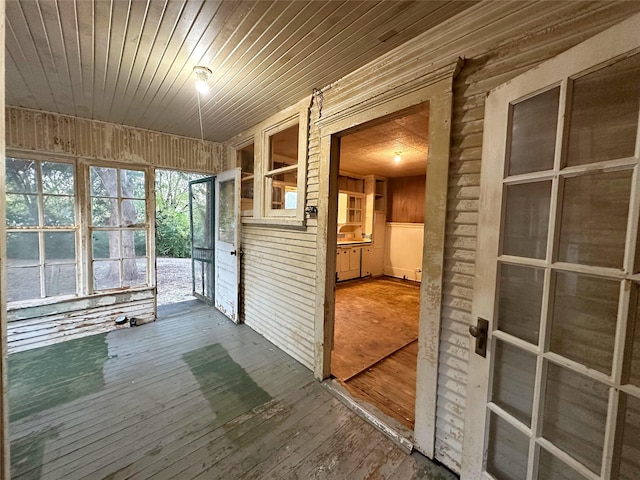 unfurnished sunroom featuring wooden ceiling