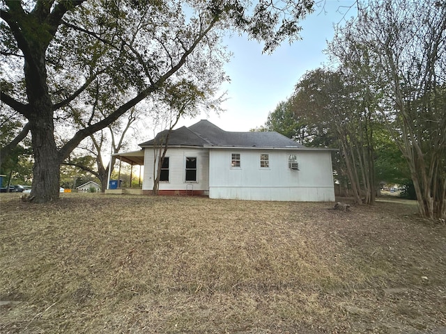 back of house with a carport