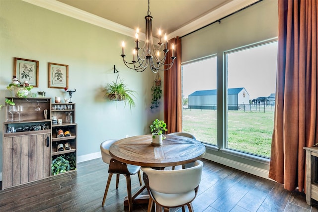 dining area featuring crown molding, dark hardwood / wood-style flooring, and a chandelier