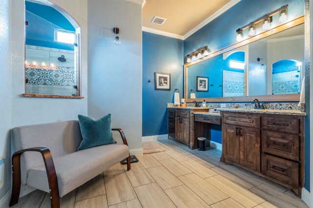 bathroom featuring vanity, crown molding, and a shower