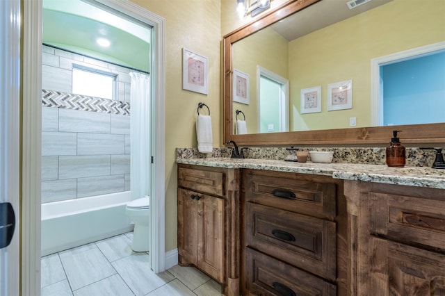 full bathroom featuring tile patterned floors, vanity, toilet, and shower / bath combo with shower curtain