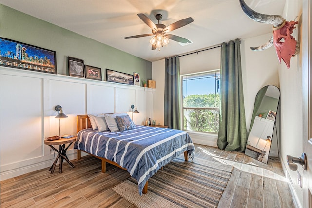 bedroom with ceiling fan and light hardwood / wood-style flooring