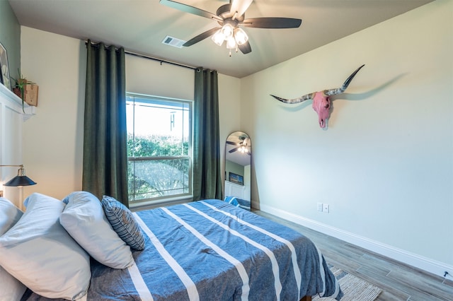 bedroom with ceiling fan and wood-type flooring