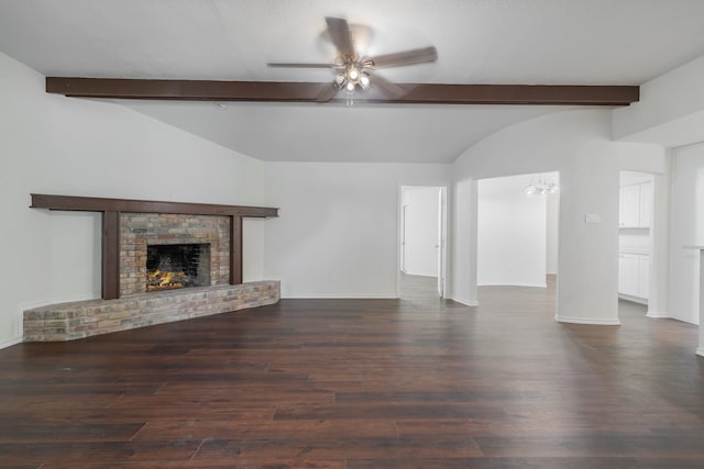 unfurnished living room featuring ceiling fan, dark hardwood / wood-style flooring, lofted ceiling with beams, and a brick fireplace