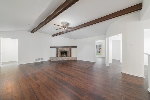 unfurnished living room featuring a fireplace, dark hardwood / wood-style flooring, lofted ceiling with beams, and ceiling fan