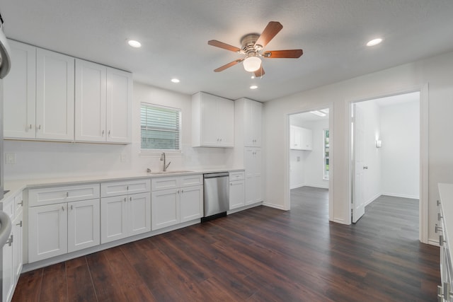 kitchen with ceiling fan, white cabinets, stainless steel dishwasher, and dark hardwood / wood-style floors