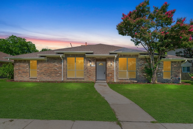 view of front of property with a lawn