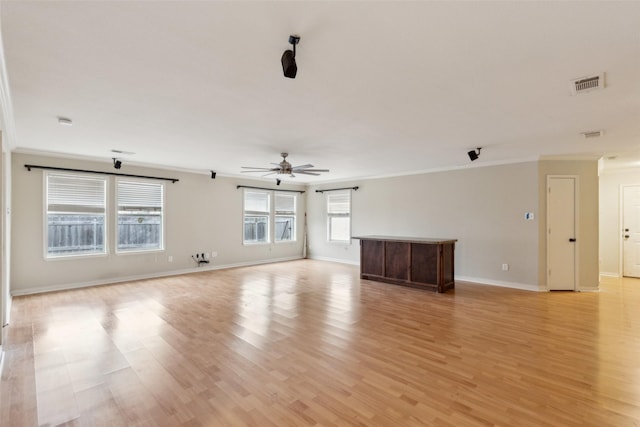 unfurnished living room featuring crown molding, visible vents, ceiling fan, light wood-type flooring, and baseboards