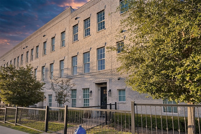 view of outdoor building at dusk