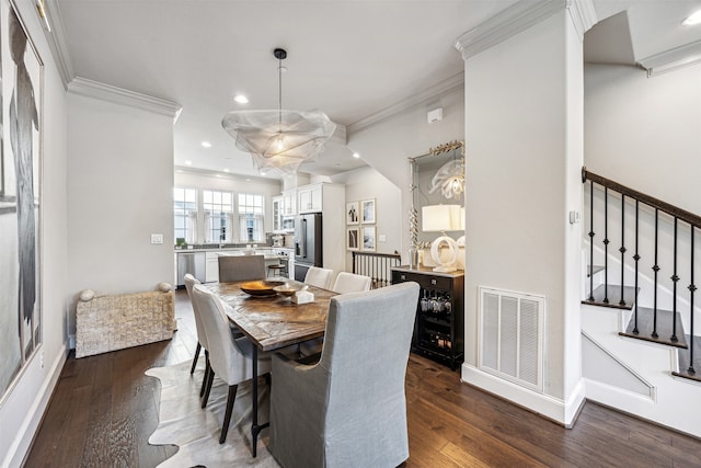 dining space featuring dark hardwood / wood-style flooring and ornamental molding