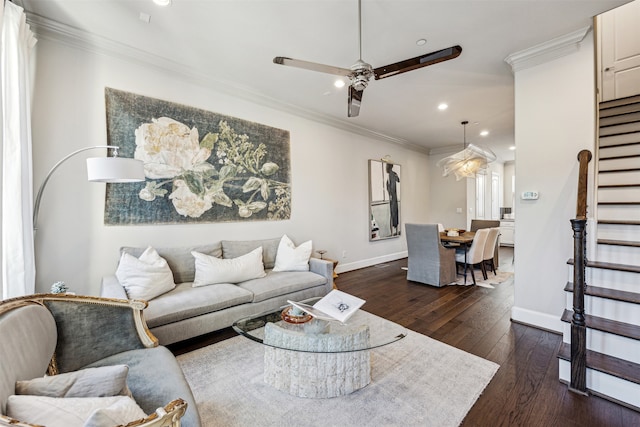 living room featuring dark hardwood / wood-style flooring, ceiling fan, and crown molding