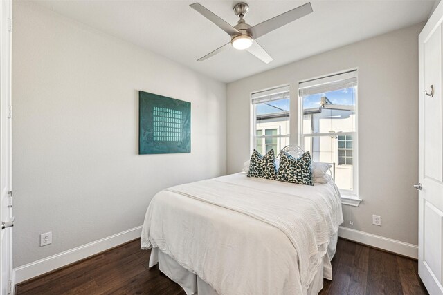 bedroom with dark hardwood / wood-style floors and ceiling fan