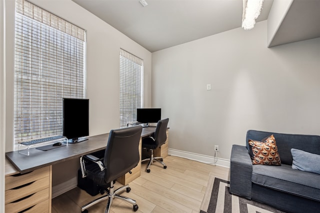 office area with plenty of natural light and light hardwood / wood-style floors