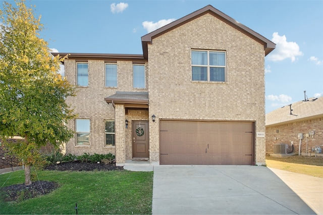 view of front of home with a front lawn, central AC unit, and a garage