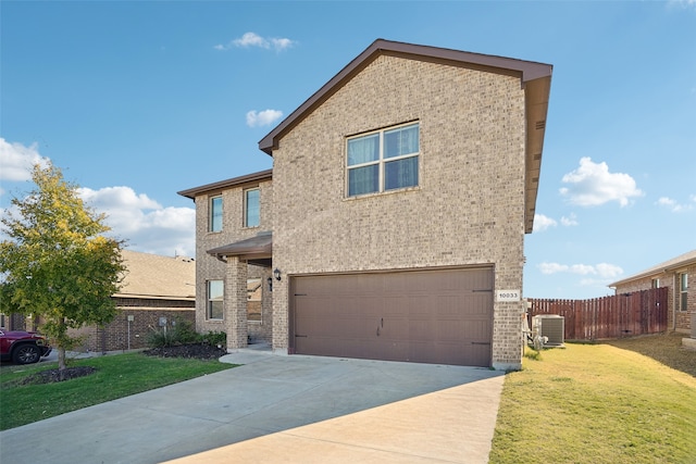 view of front of property featuring a front yard and a garage