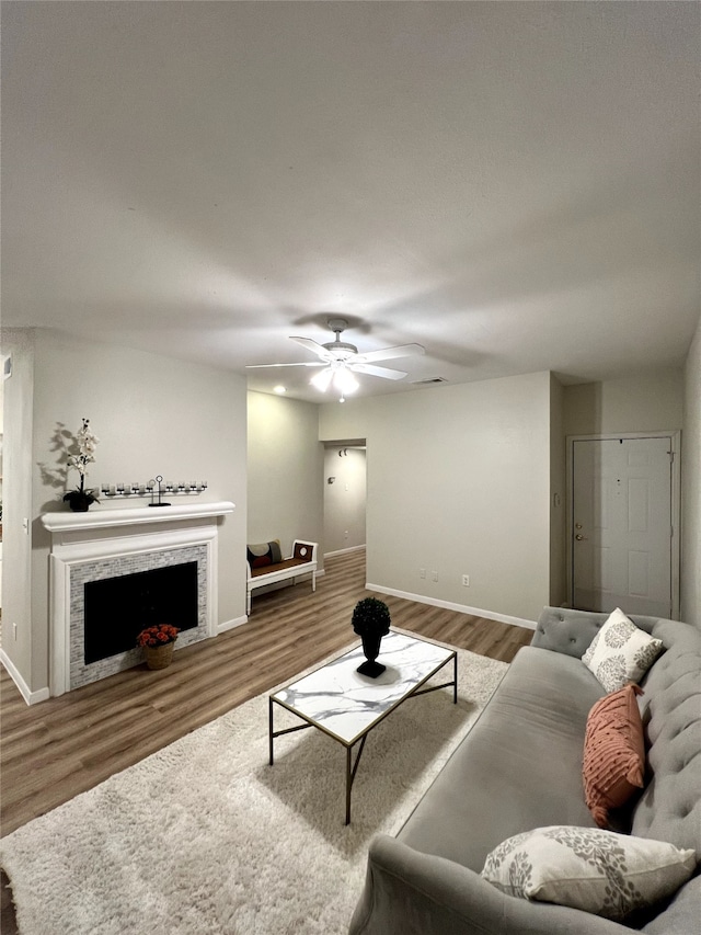 living room featuring ceiling fan and wood-type flooring