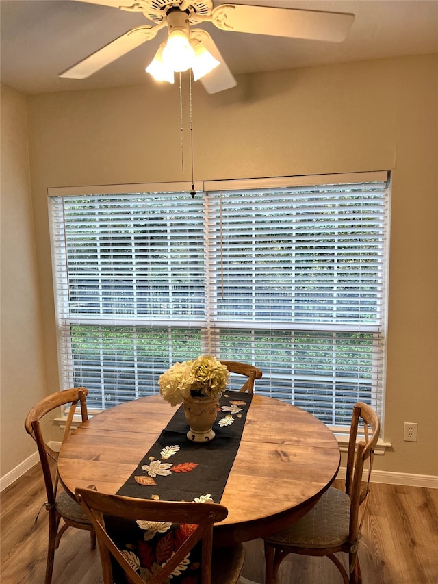 dining area with ceiling fan and wood-type flooring